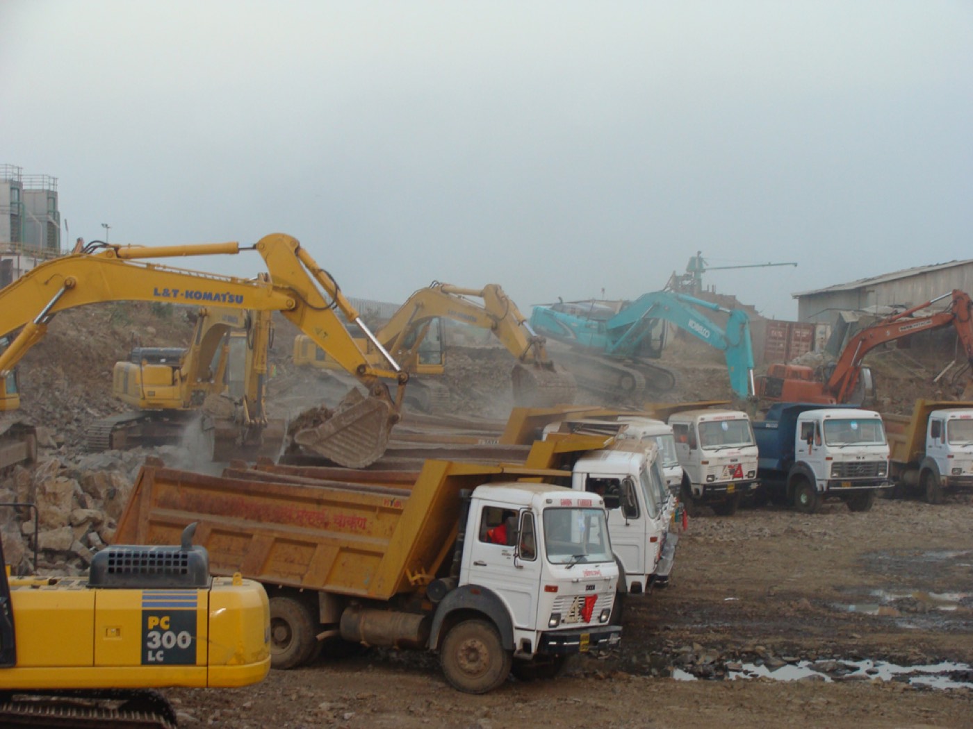 P K Infraproject earthmoving machinery levelling an industrial plot near Pune